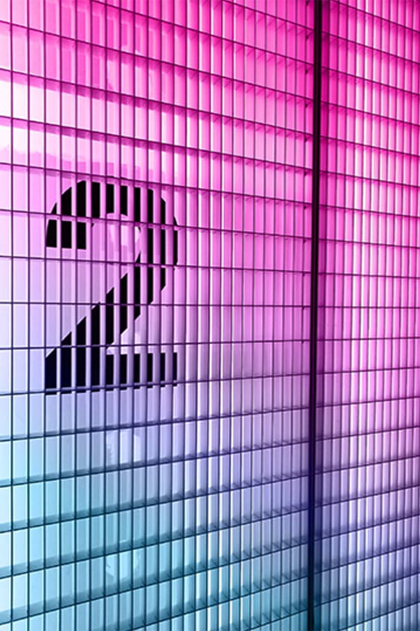 The number 2 over a window of neon lights pink at the top to blue at the bottom.